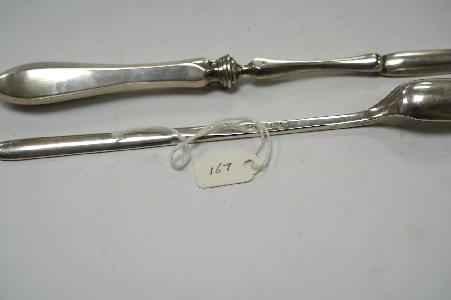 An Elizabeth II silver marrow scoop, by Francis Howard Ltd, Sheffield, 1977, 21.6cm, together with a Dutch 833 standard white metal marrow scoop. Condition - fair